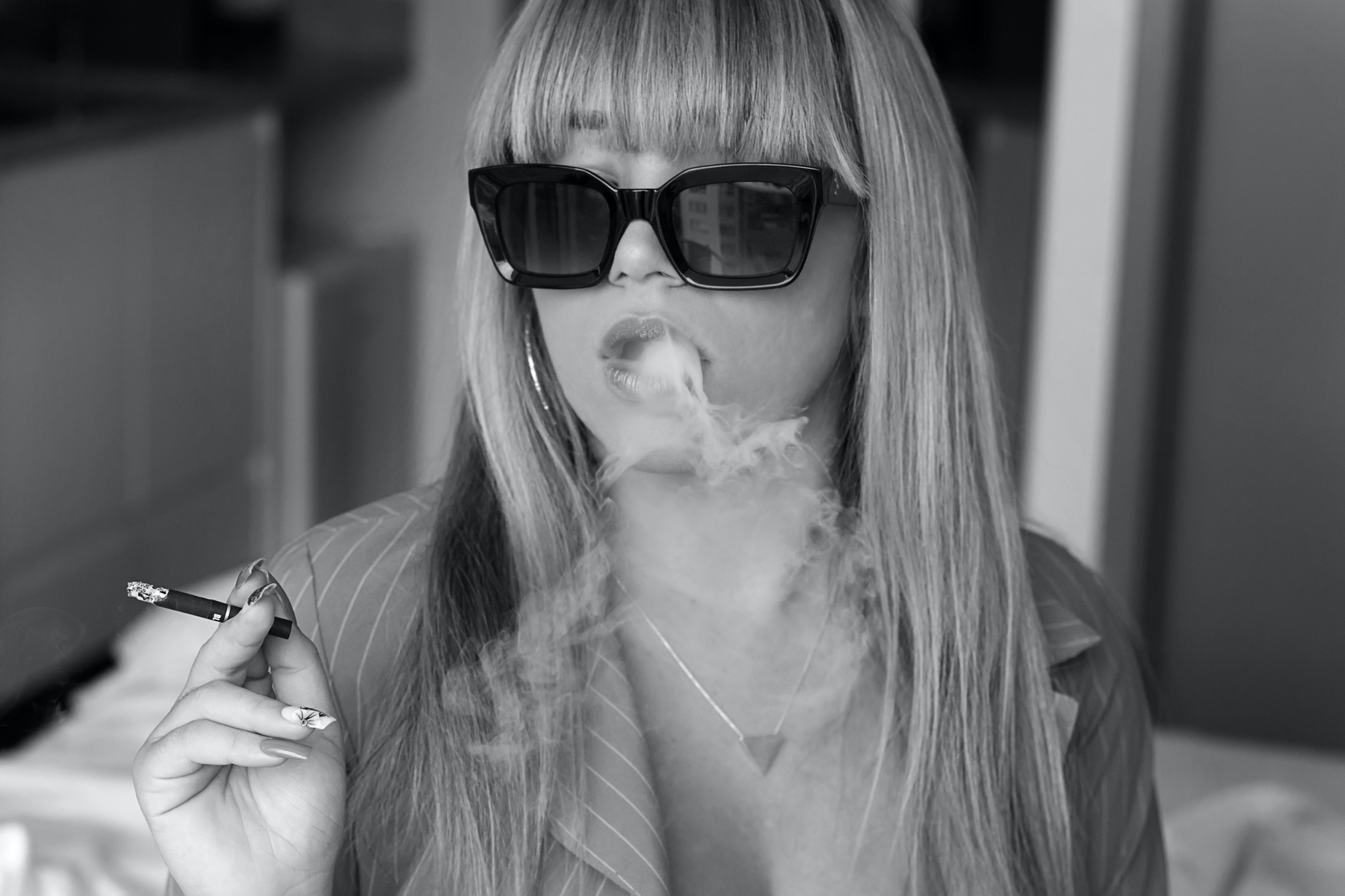 Sexy girl smoking with glasses