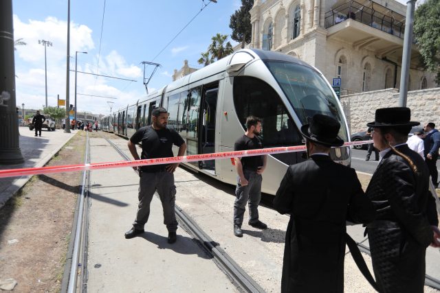 Israeli policemen block a road where the light train passes following a stabbing attack just outside Jerusalem's Old City, according to Israeli police April 14, 2017. REUTERS/Ammar Awad