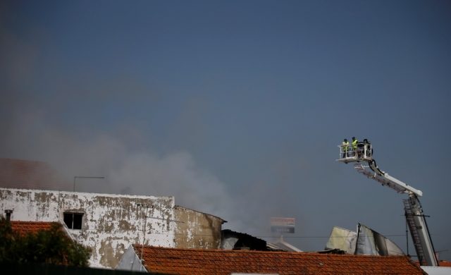 Smoke is seen where a small airplane crashed near a supermarket in a residential area outside Lisbon, Portugal April 17, 2017. REUTERS/Rafael Marchante