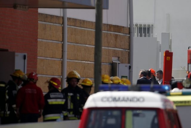 Firefighters work where a small airplane crashed near a supermarket in a residential area outside Lisbon, Portugal April 17, 2017. REUTERS/Rafael Marchante